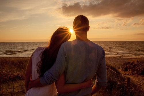 Couple talking outdoors at sunset